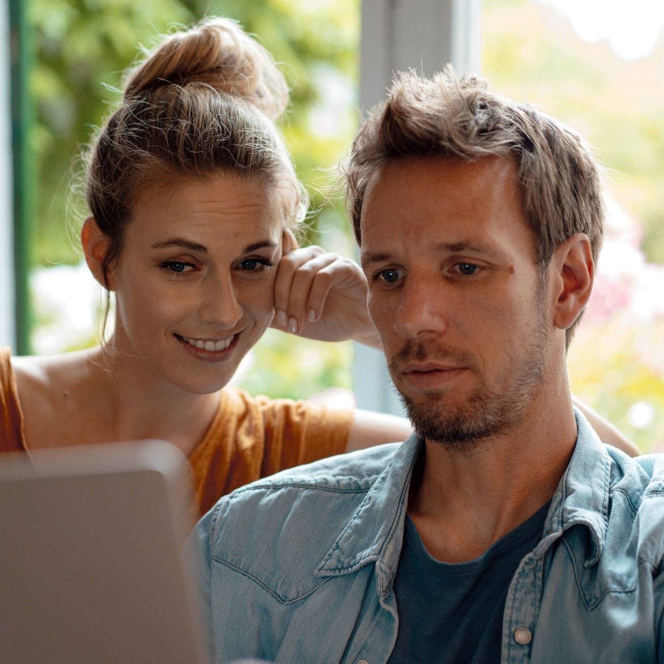 Mann und Frau sitzen vorm Laptop.
